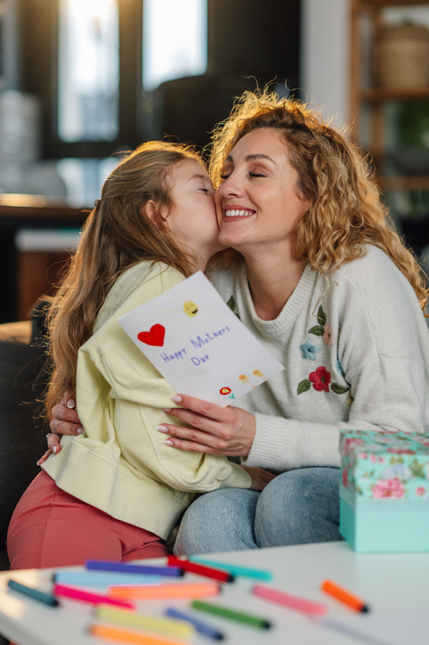 Mom and Daughter sitting in the living room celebrating mother's day
